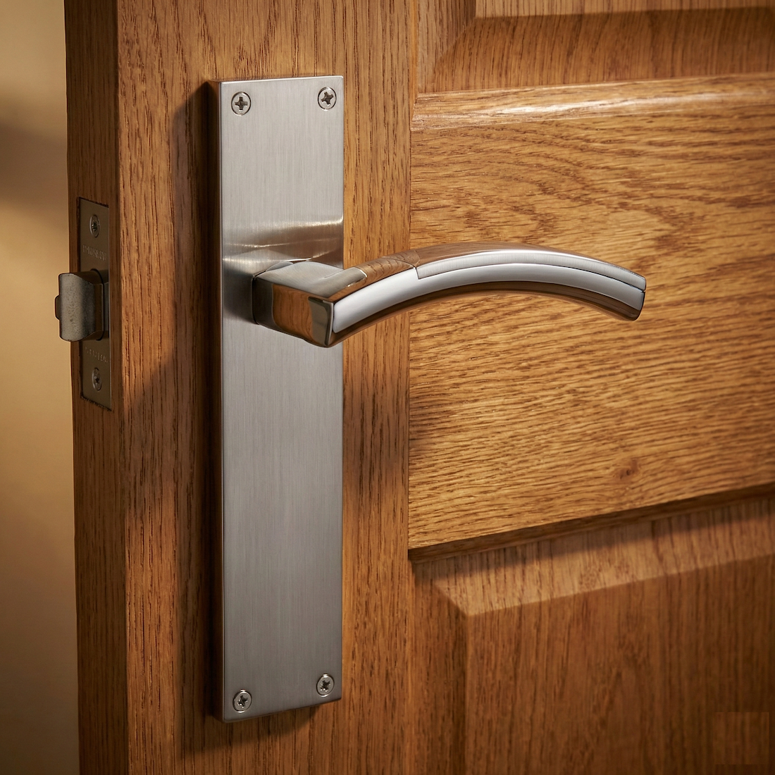 Manilla modelo '420' de zamak en acabado bicolor con placa rectangular para puertas