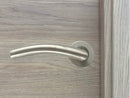 Manilla inoxidable curva para puertas de madera clara