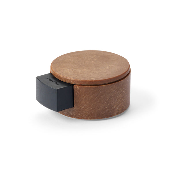 Self-adhesive wood-finish plastic stopper with cushioning mechanism