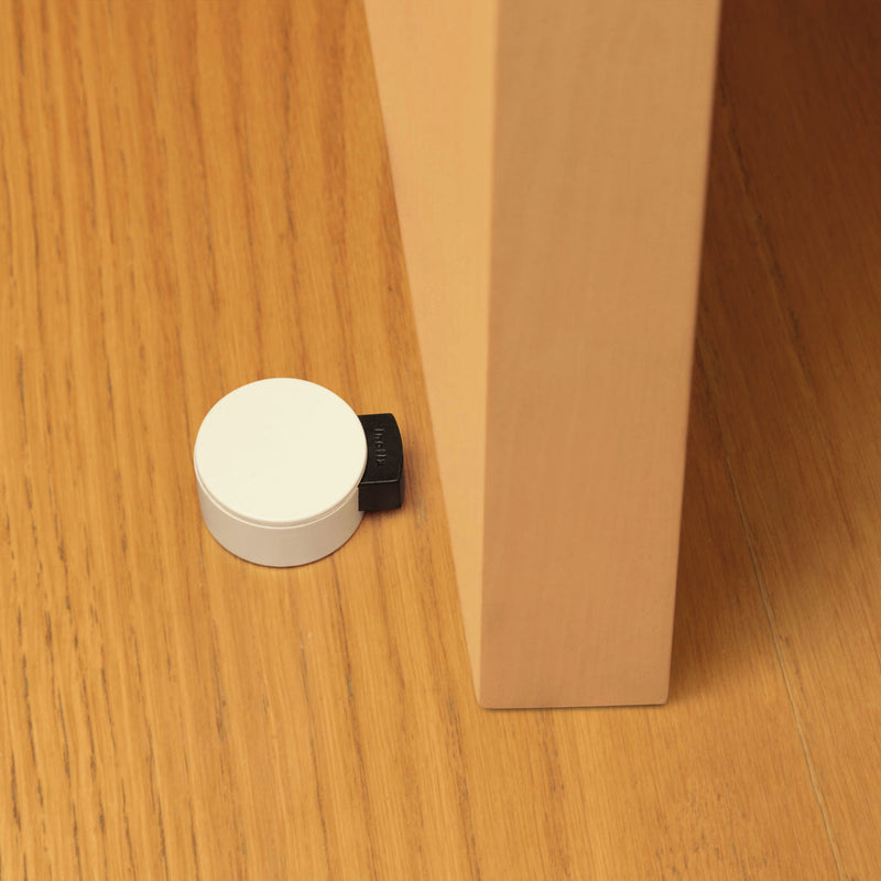 White finished plastic self-adhesive stopper with cushioning mechanism