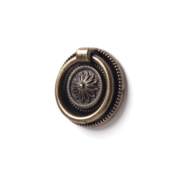 Clásica anilla redonda de zamak en acabado cuero viejo con relieve de flor de 38ø para armarios